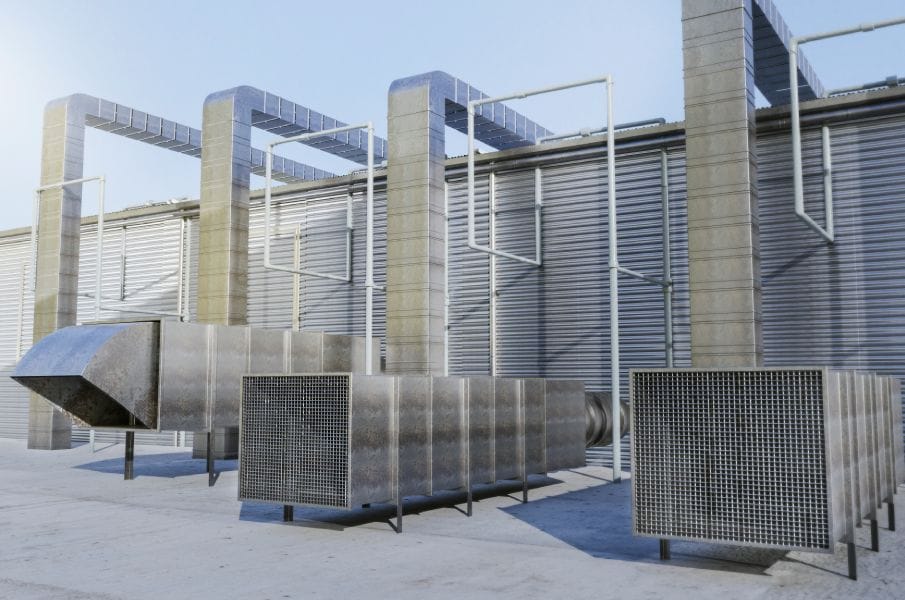 Commercial mechanical room with HVAC ductwork, equipment, and piping.