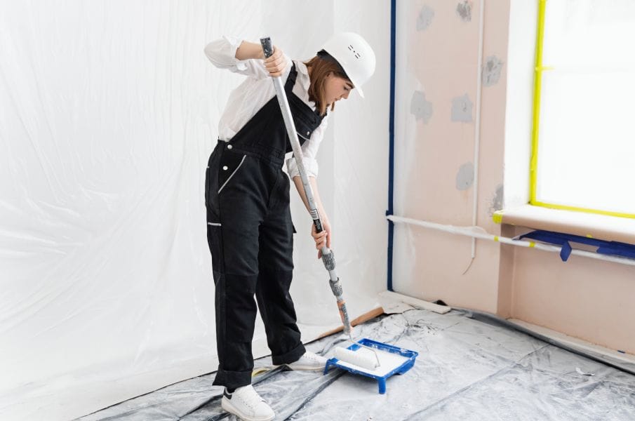 Professional painter applying interior coatings in a commercial space.