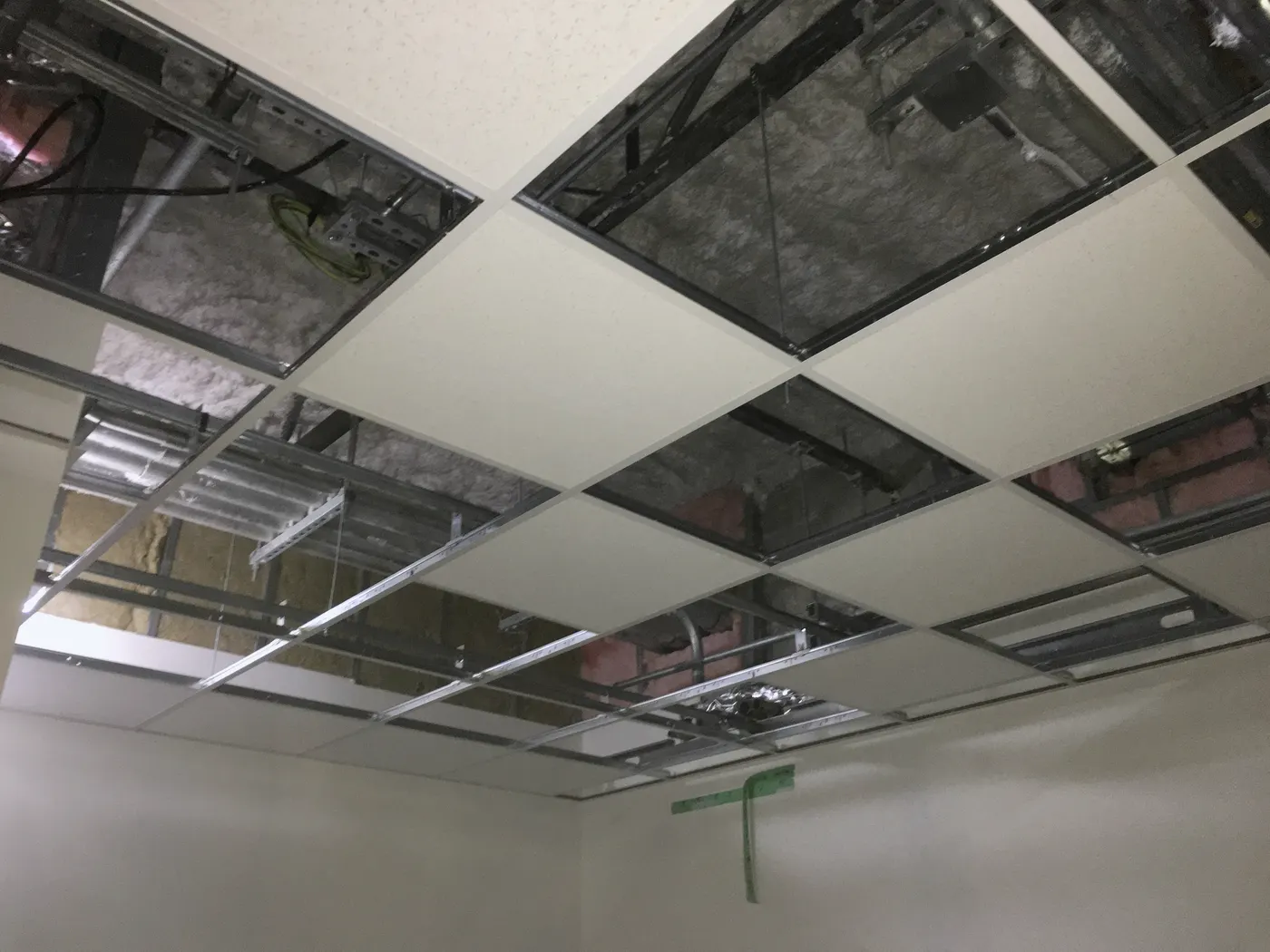 Acoustical ceiling with varied elevations, grid, lighting, diffusers, and access panels