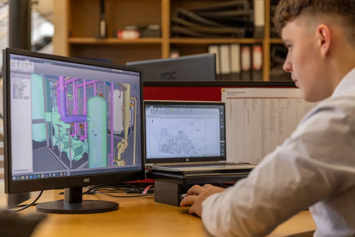 Estimator working with a BIM model and project drawings on multiple monitors