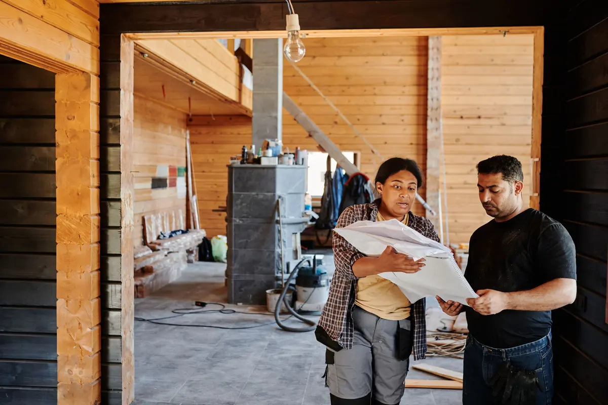 Construction team reviewing plans for change order estimating on an active project
