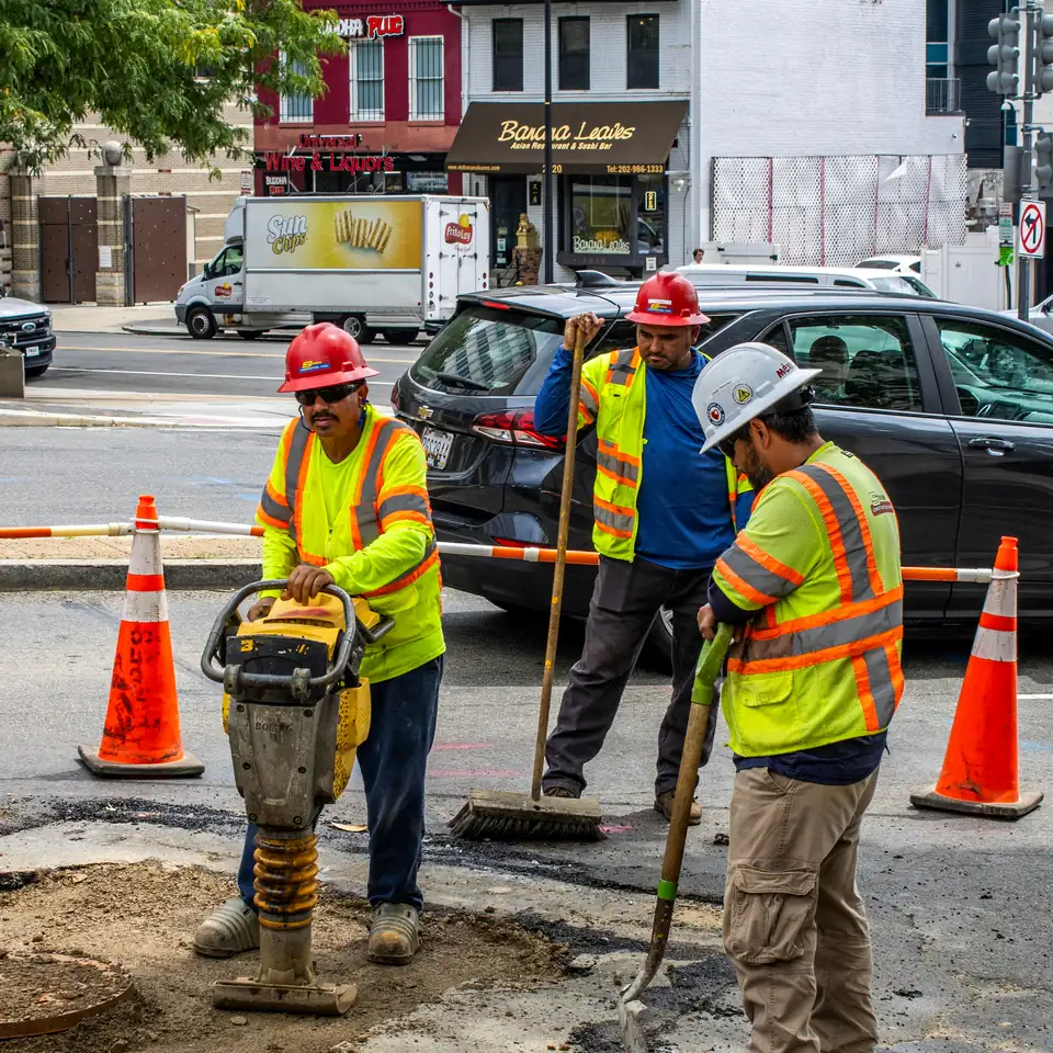 Road crew performing utility work on a public street