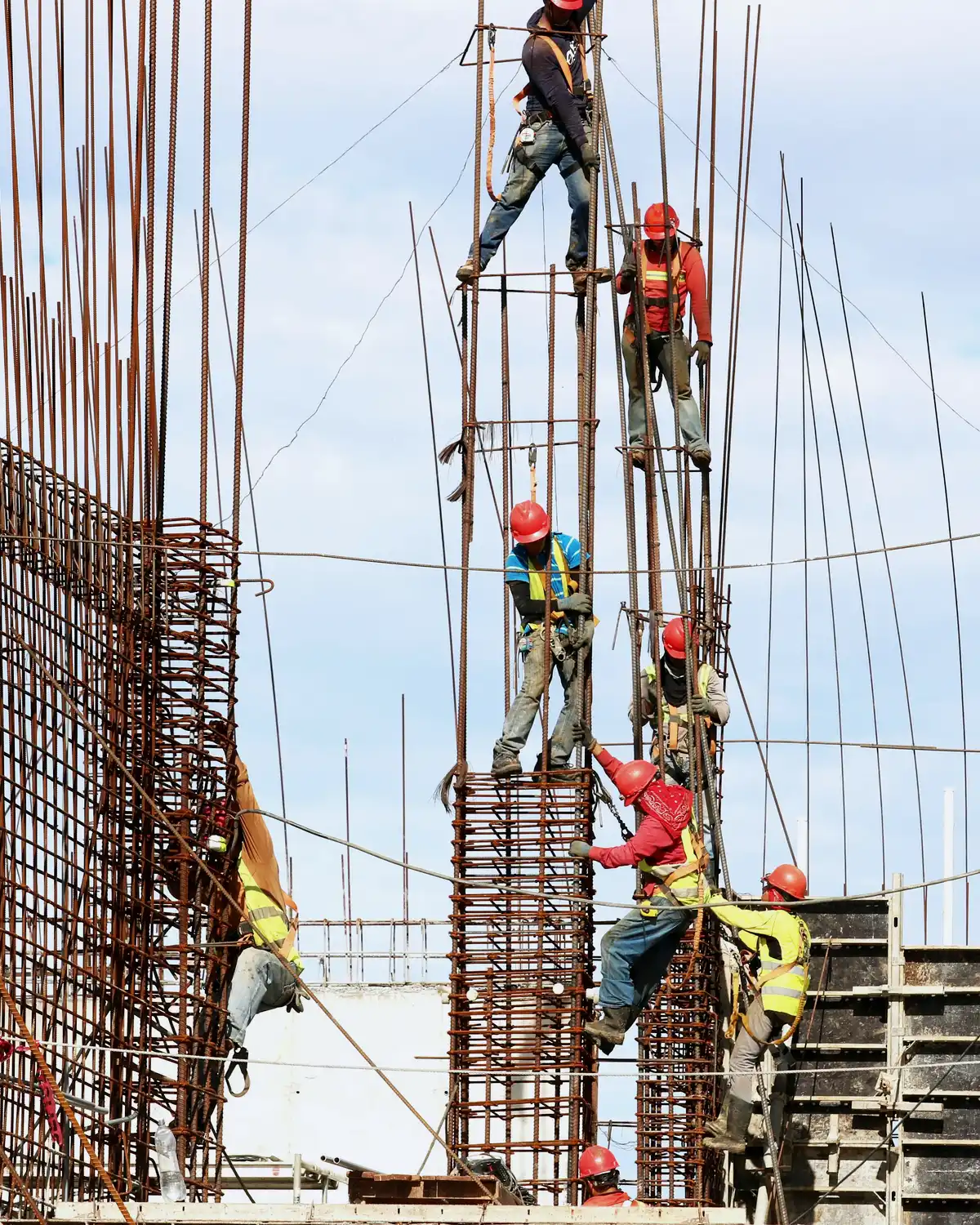 Concrete crew working around reinforced concrete formwork on an active construction site