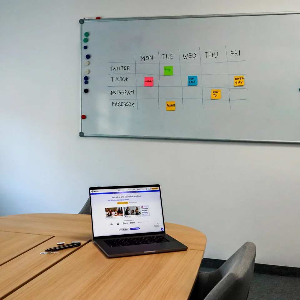 Bid management workspace with weekly deadline board and laptop