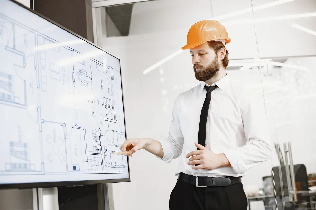 Construction professional presenting project drawings during bid preparation