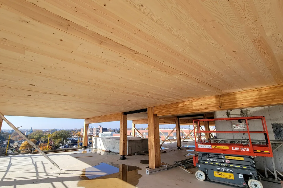 Modern U.S. building project under construction with timber framing and access equipment