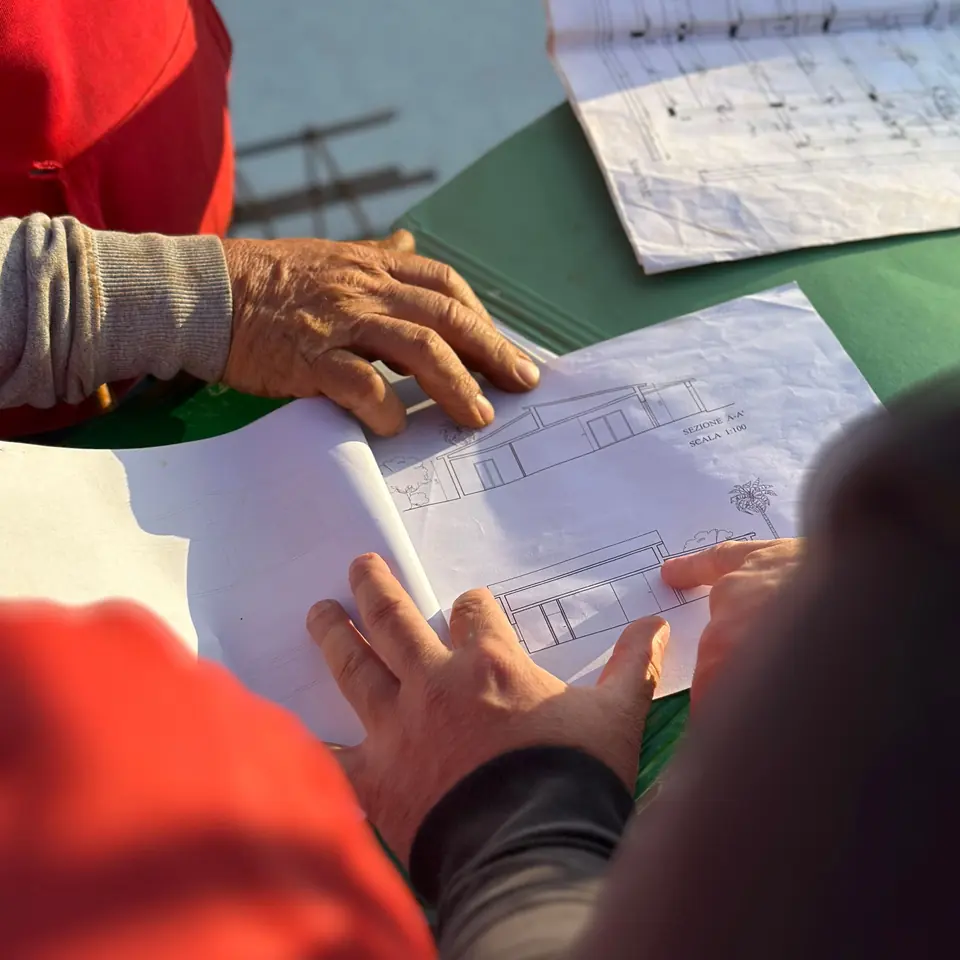 Construction professionals reviewing project drawings during cost estimating scope review