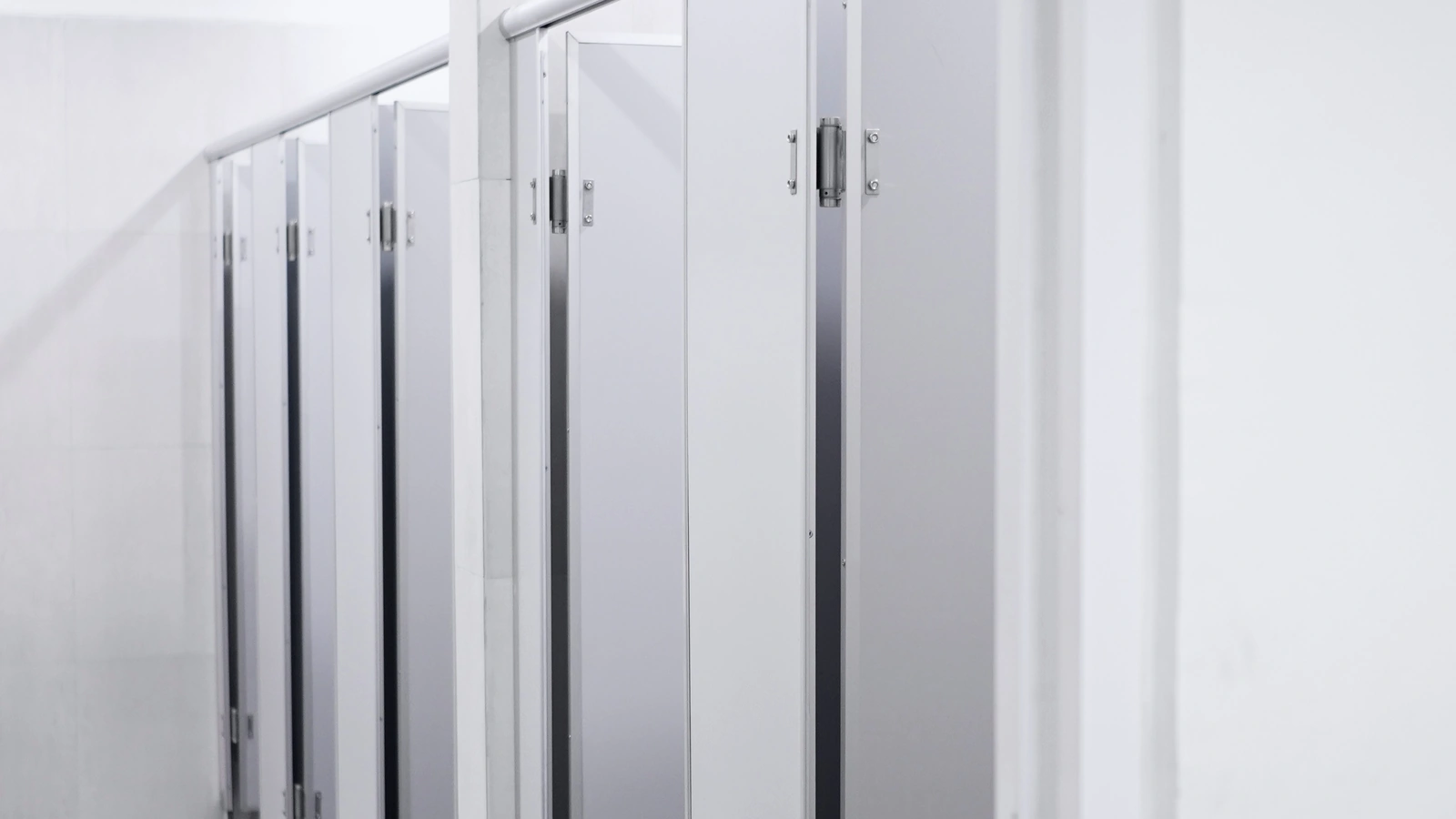 Commercial restroom with toilet partitions, doors, hinges, and specialty hardware.