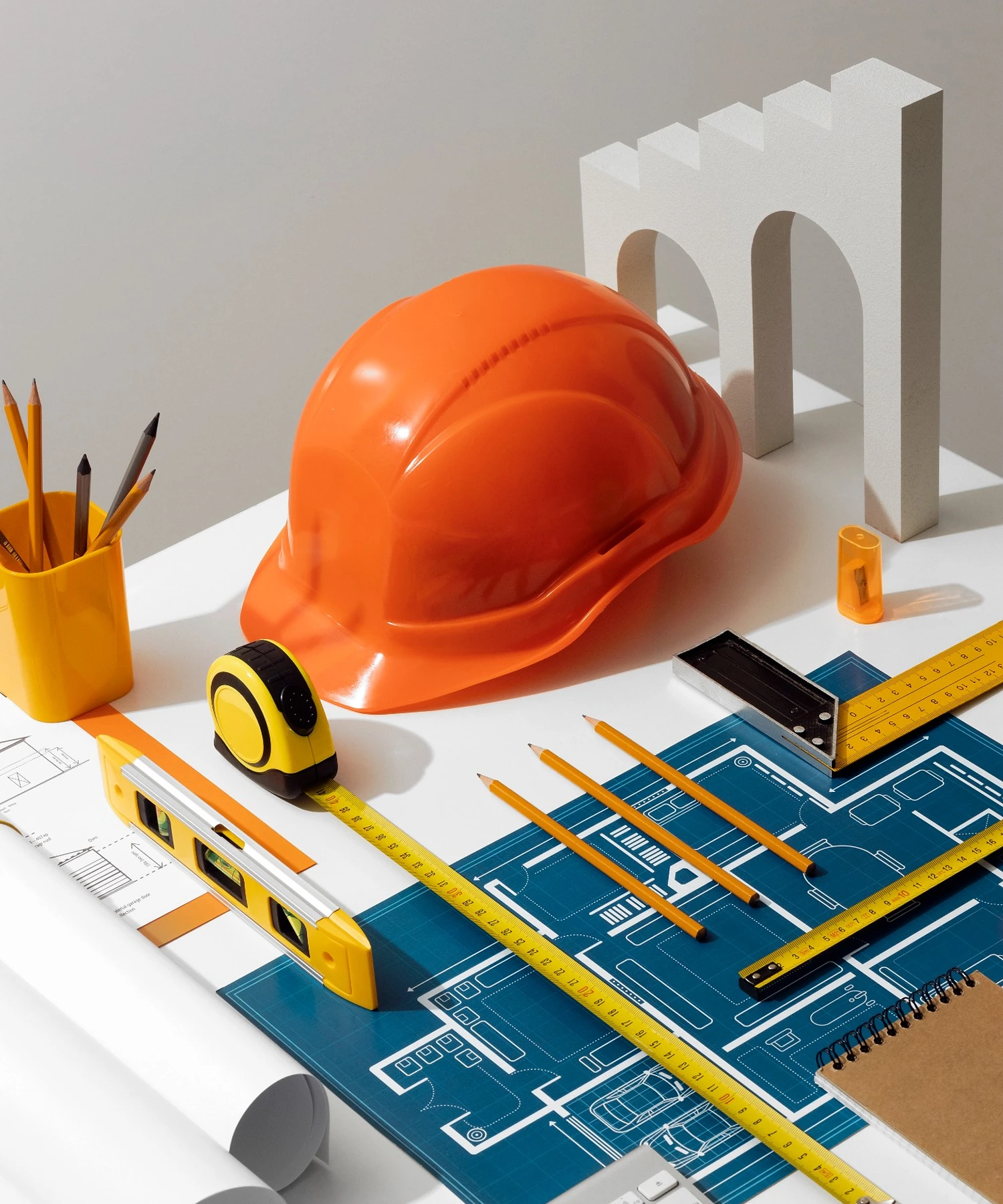 Construction plans and estimating tools arranged on an organized preconstruction workstation.