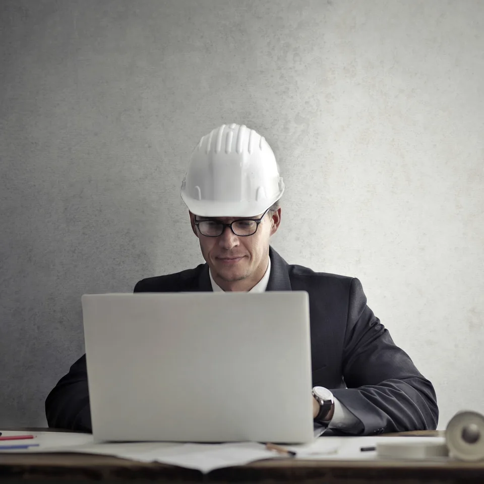 Construction estimator working independently at a laptop