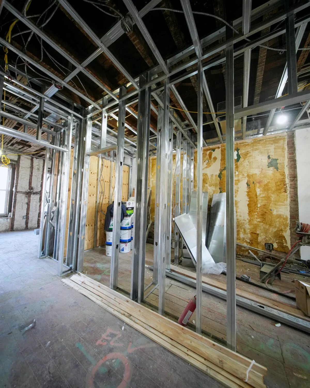Commercial interior with metal stud framing and drywall installation in progress