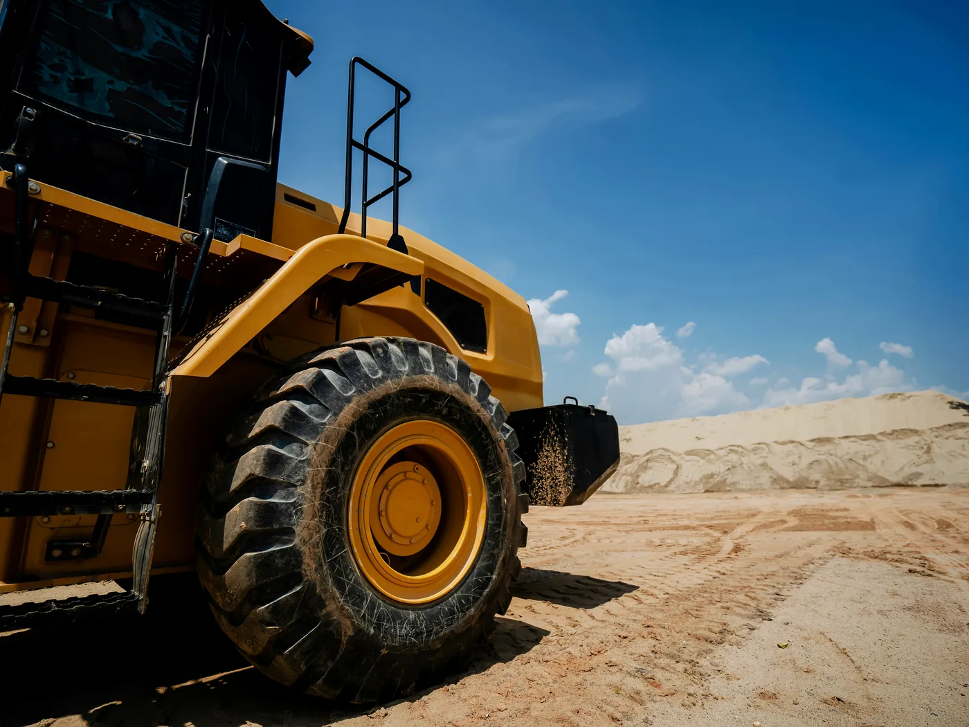 Earthwork site with cut and fill areas, stockpiles, and equipment access routes