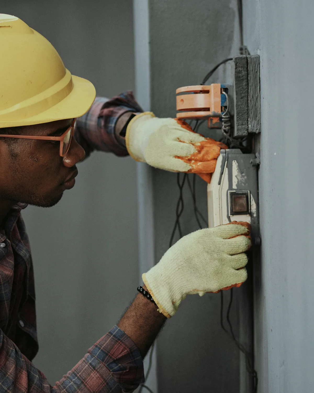 Electrician installing conduit and distribution equipment in a commercial building