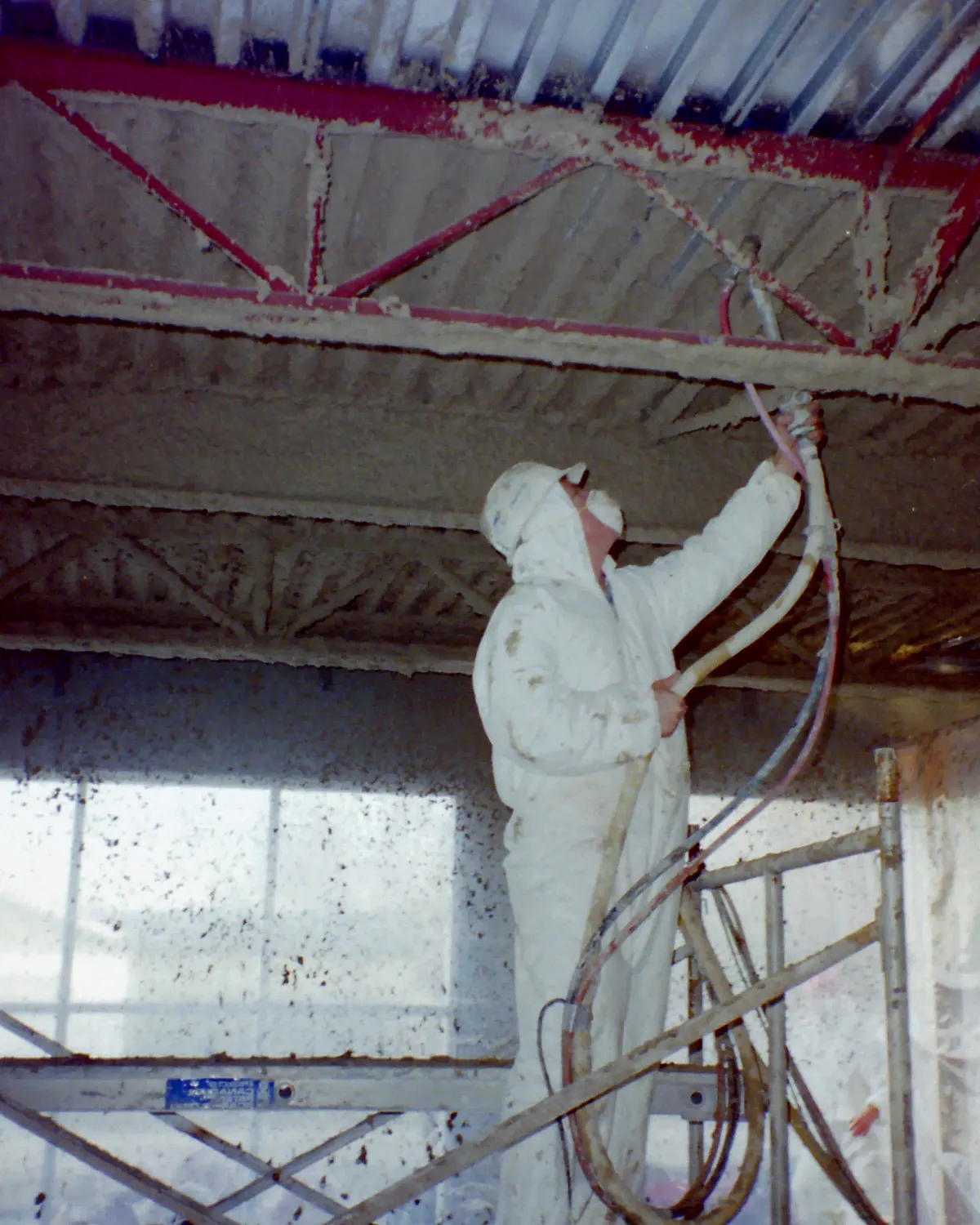 Installer applying passive fire-protection material to structural and penetration conditions