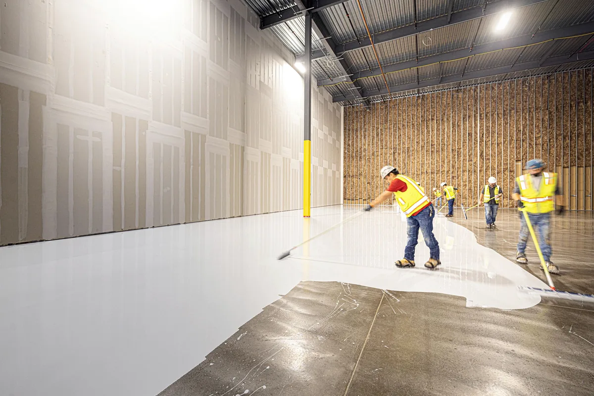 Construction workers installing a concrete floor in Dallas, Texas