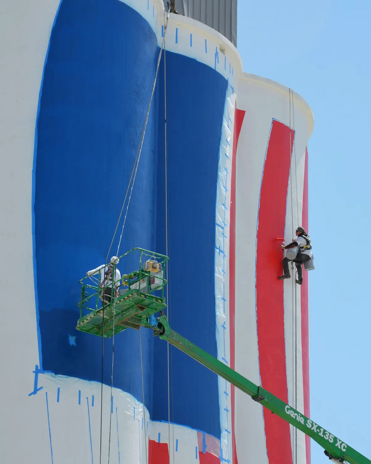Commercial painter applying an interior coating system on an active project