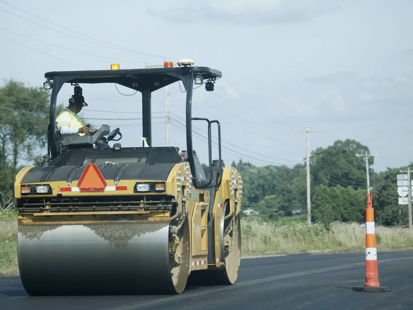 Commercial paving project with curbs, drainage, equipment access, and phased work areas
