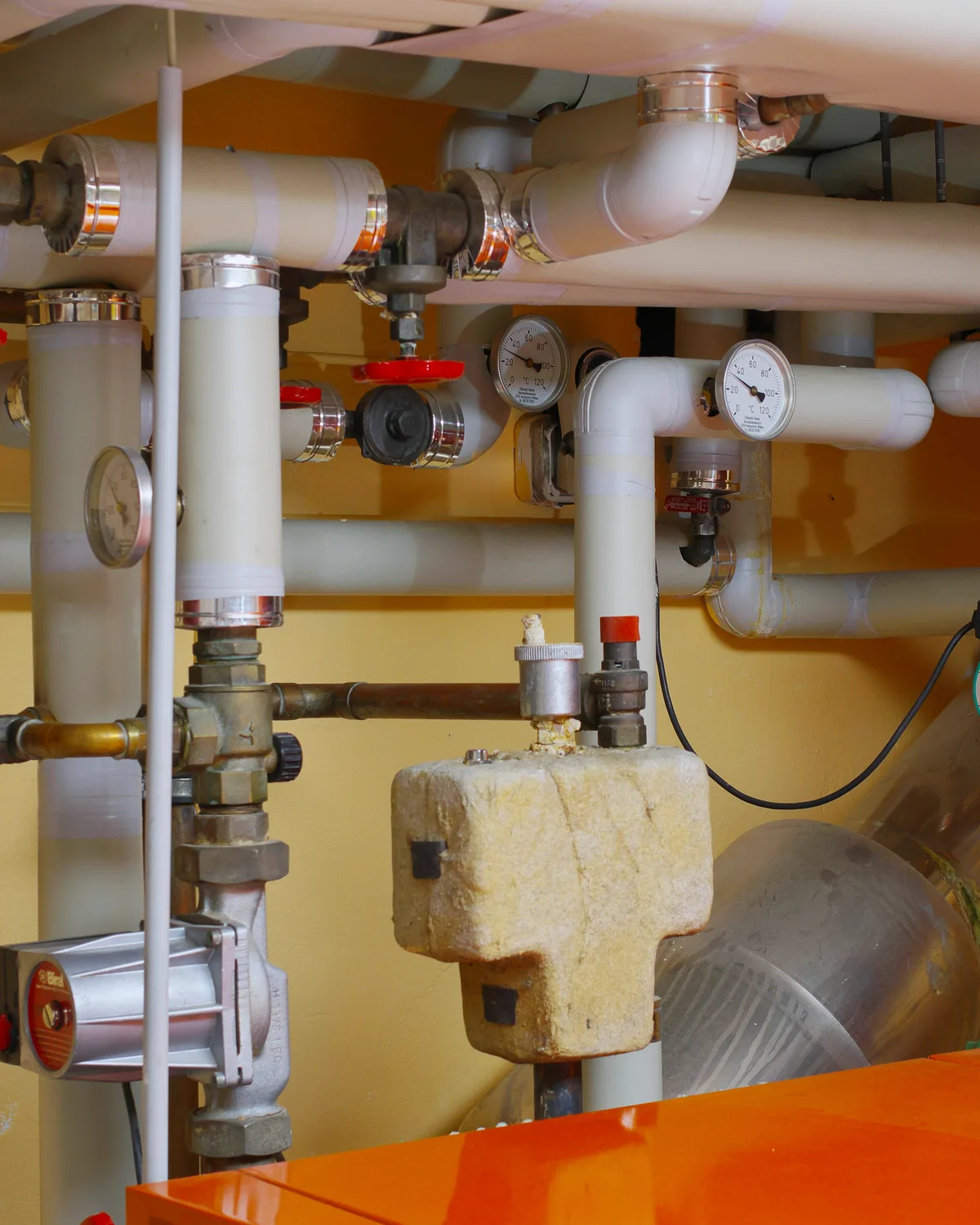 Plumber installing commercial water and sanitary piping systems