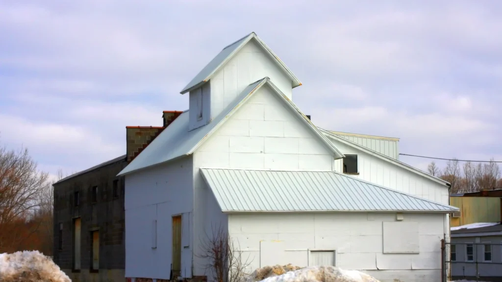 Existing residential building with an addition connected to the original structure.