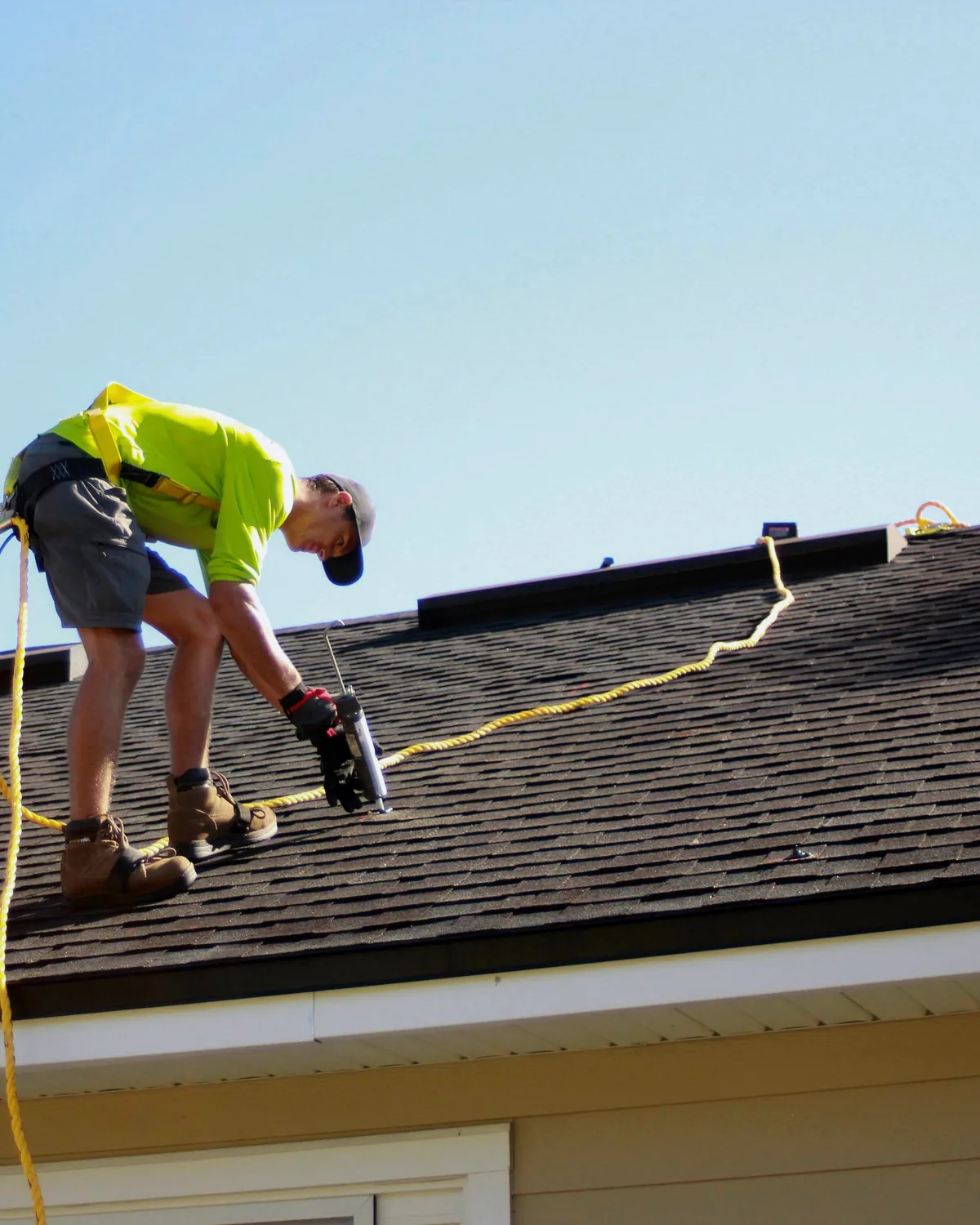 Commercial roofing crew installing membrane and insulation on a flat roof