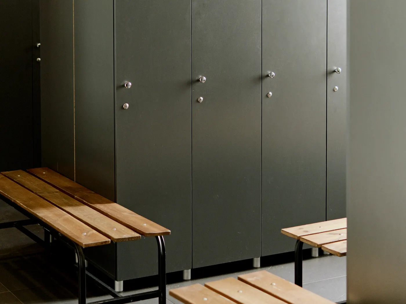 Commercial interior with toilet compartments, accessories, lockers, signage, and wall protection