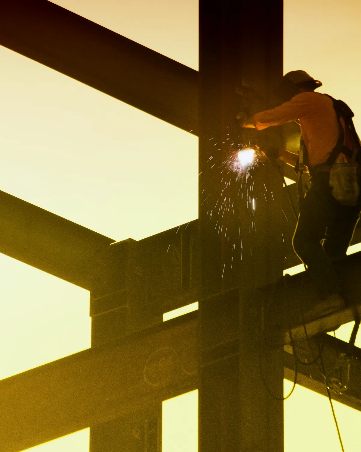 Structural steel frame with beams, columns, joists, and decking under construction