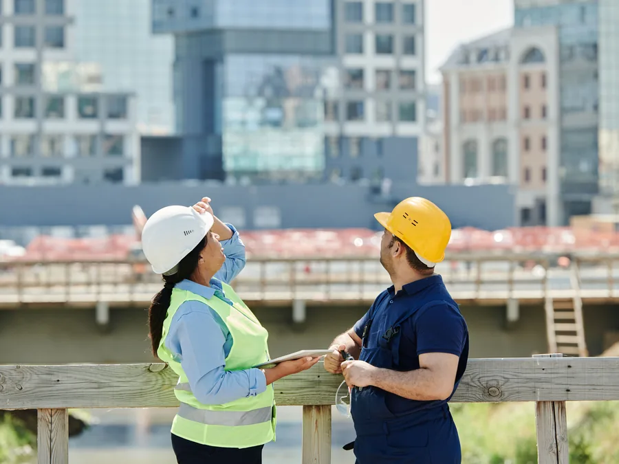 General contractor team reviewing project information at an active commercial construction site