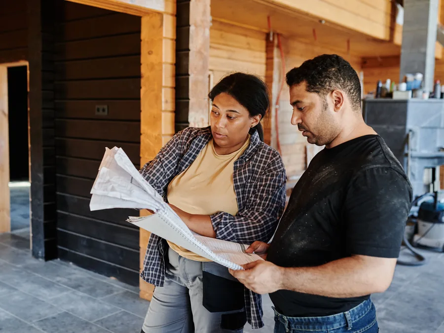 Subcontractors reviewing trade drawings inside a construction project